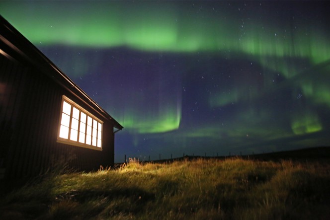 The Northern Lights over the Holkna Studio in Iceland.
